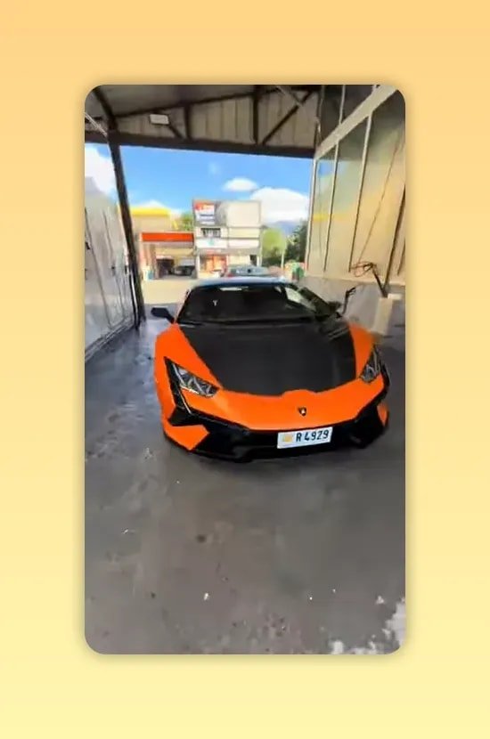 Voiture sportive orange vue de face sous un abri de lavage